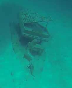Underwater Mermaid Playing Piano in Exuma Islands Bahamas.